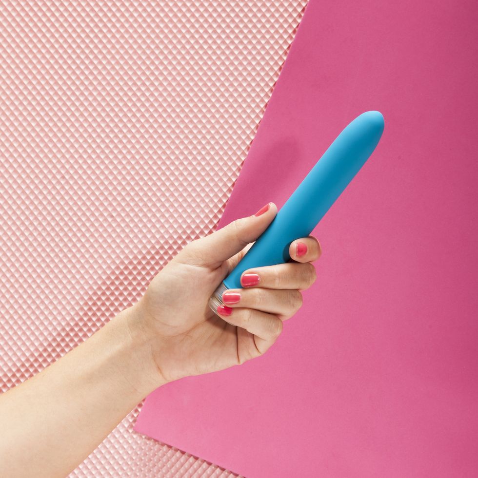 Young woman holding a vibrator